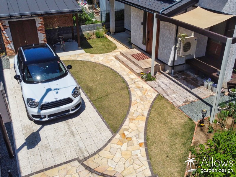 ナチュラルな舗装材を使用した、アプローチと駐車スペース。